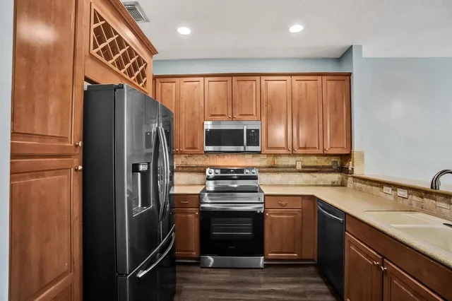 a kitchen with a refrigerator stove and sink