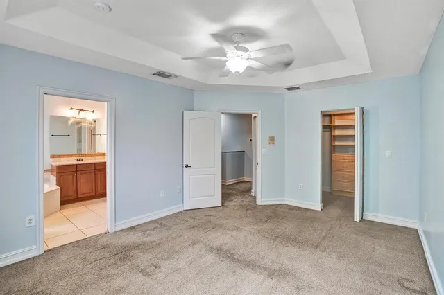 a view of a room with a stylish ceiling fan and entryway