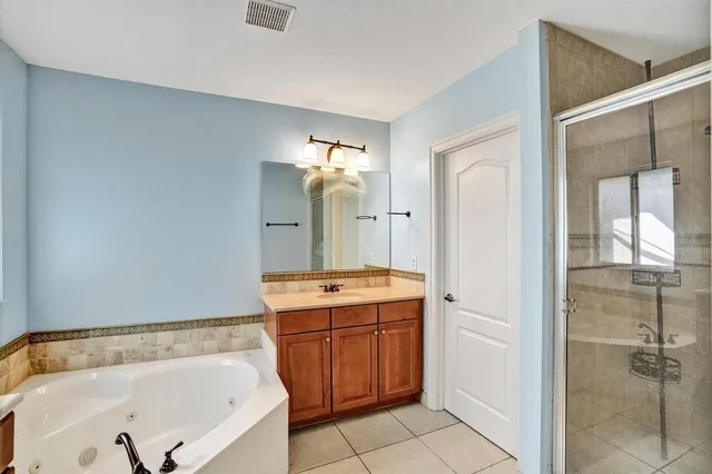 a bathroom with a tub sink and mirror