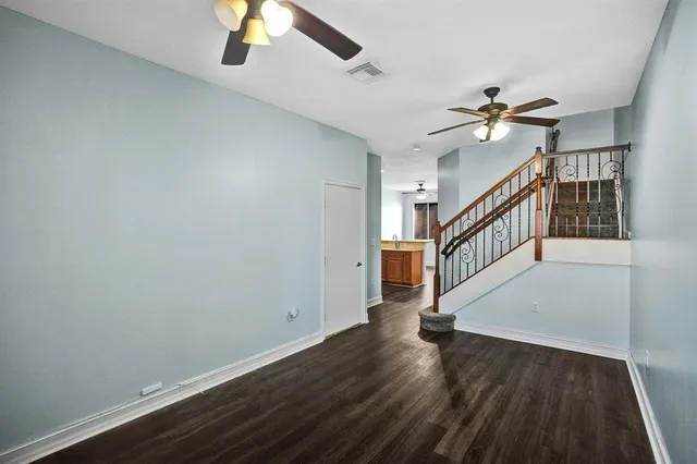 a view of a hallway with wooden floor and staircase