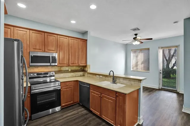a kitchen with a sink stove and microwave