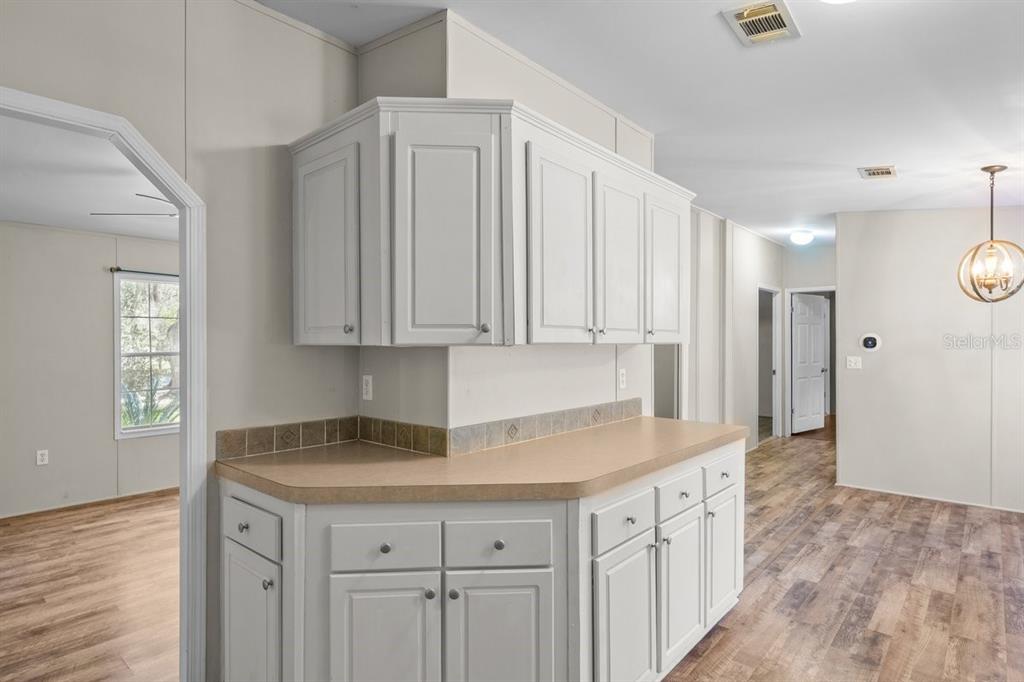 218 Northeast 132nd Terrace Gainesville, FL 32641 - Photo 15 of 40 a kitchen with white cabinets and sink