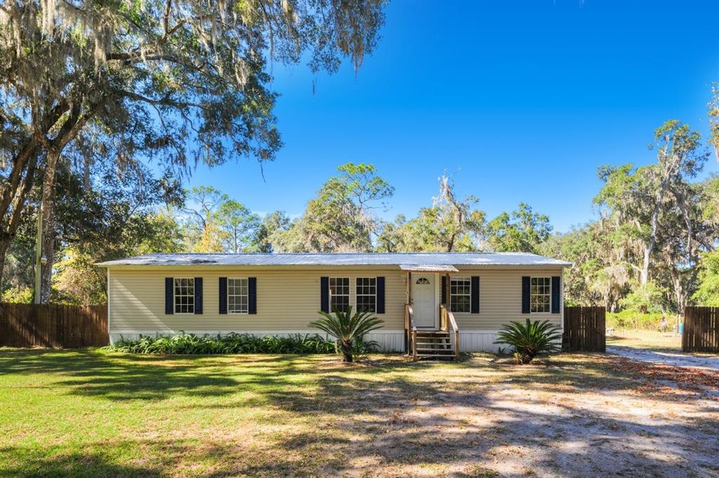 218 Northeast 132nd Terrace Gainesville, FL 32641 - Photo 2 of 40 a view of a house with a patio