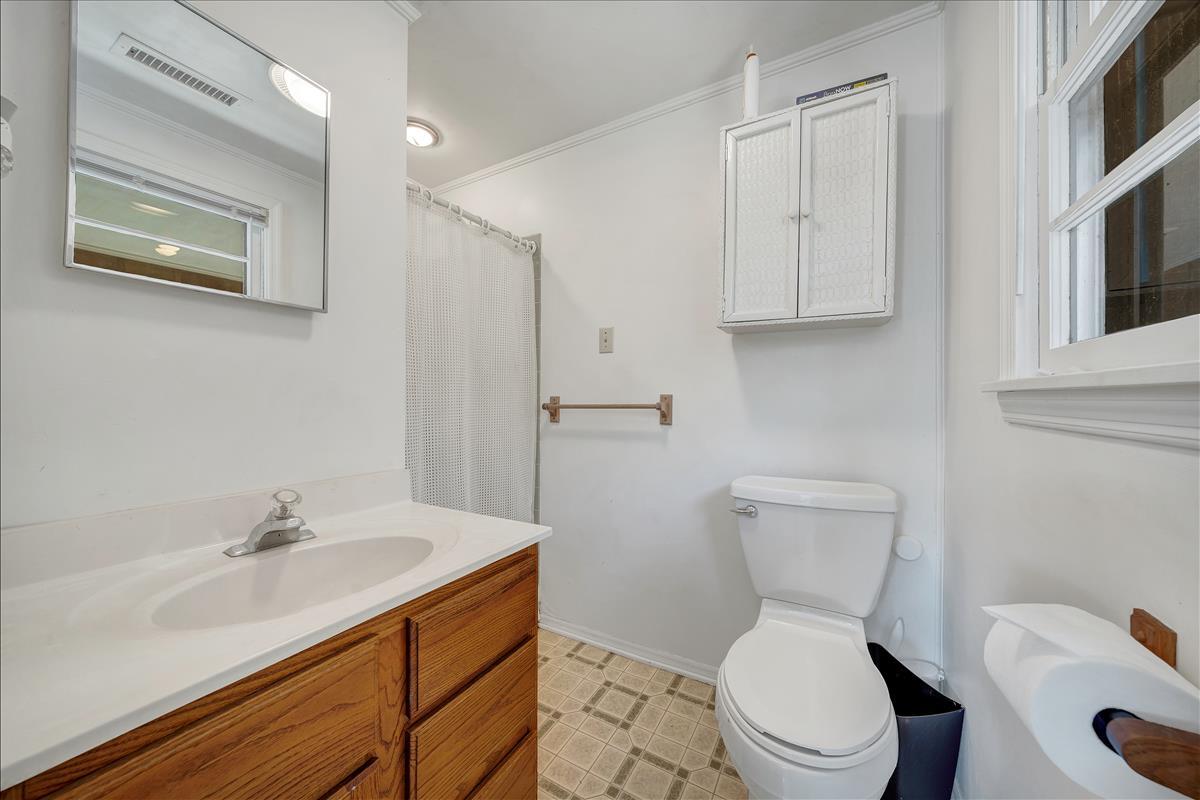 1456 Lynville Ford Road Goodview, VA 24095 - Photo 17 of 45 a bathroom with a sink toilet and vanity