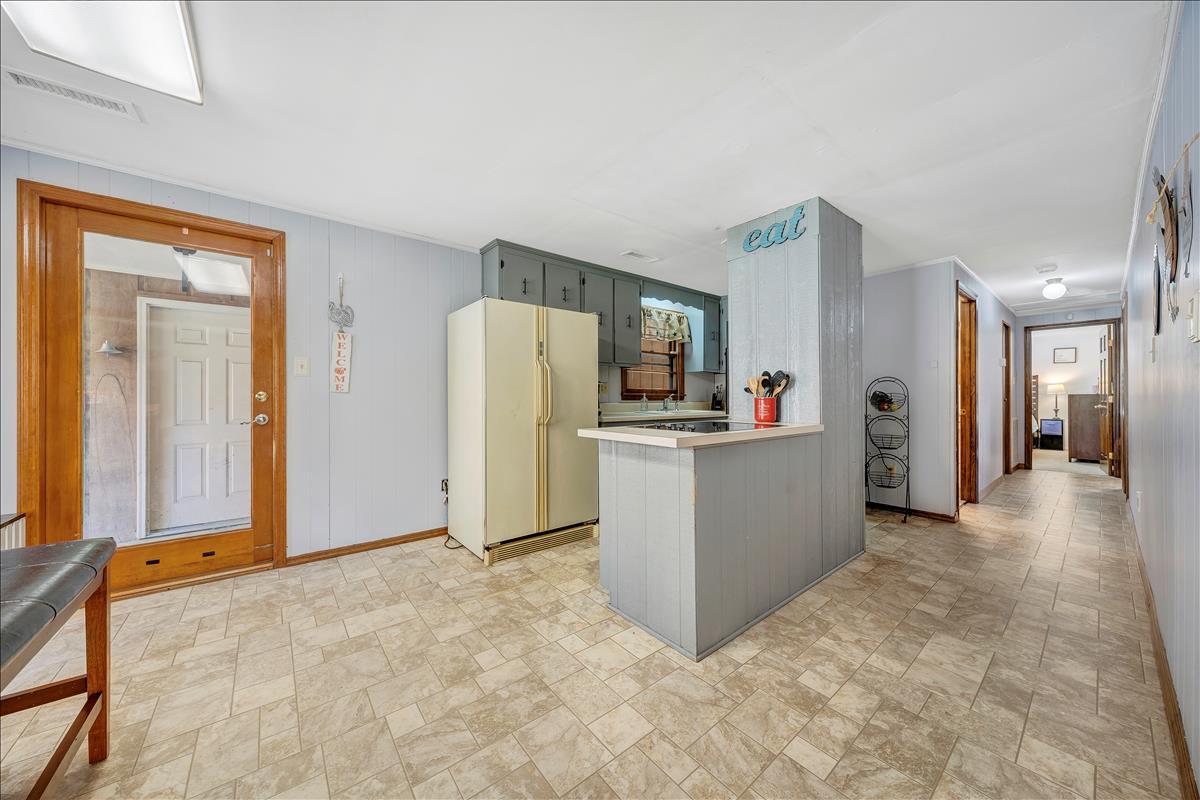 1456 Lynville Ford Road Goodview, VA 24095 - Photo 5 of 45 a view of a kitchen with refrigerator and windows