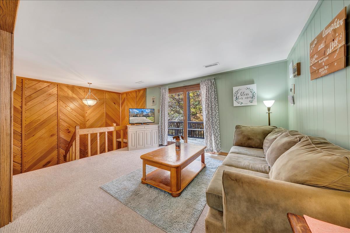 1456 Lynville Ford Road Goodview, VA 24095 - Photo 10 of 45 a living room with a couch and a floor to ceiling window