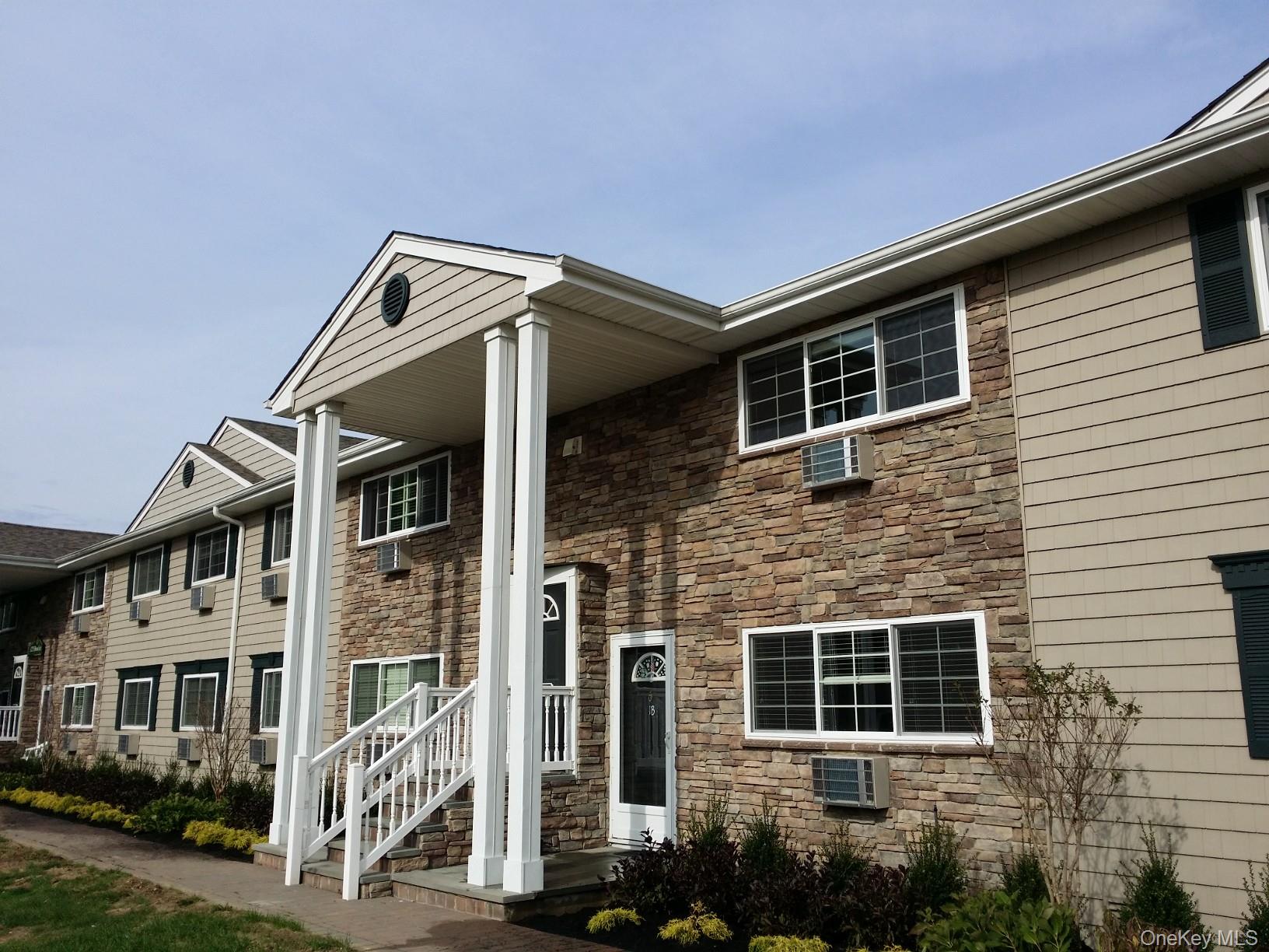 331 Brook Avenue, Unit 2B Bay Shore, NY 11706 - Photo 1 of 1 a front view of a house with garden