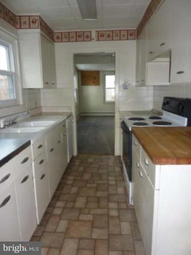 104 Poplar Road Riva, MD 21140 - Photo 2 of 13 a kitchen with a stove sink and cabinets