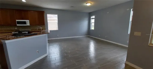 a kitchen with a refrigerator sink and stove top oven