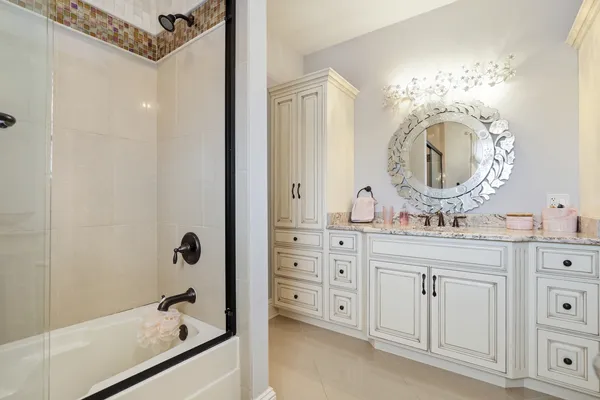 a bathroom with a sink mirror and vanity