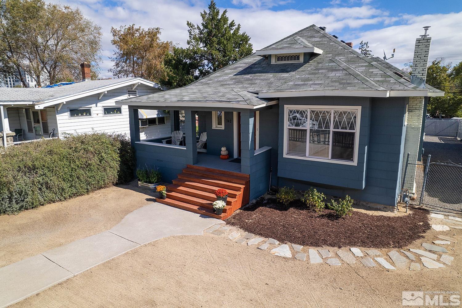 742 Plumas Street Reno, NV 89509 - Photo 1 of 40 a front view of a house with a yard and outdoor seating