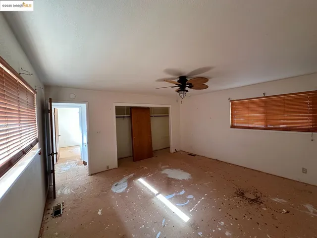 an empty room with a empty space and windows