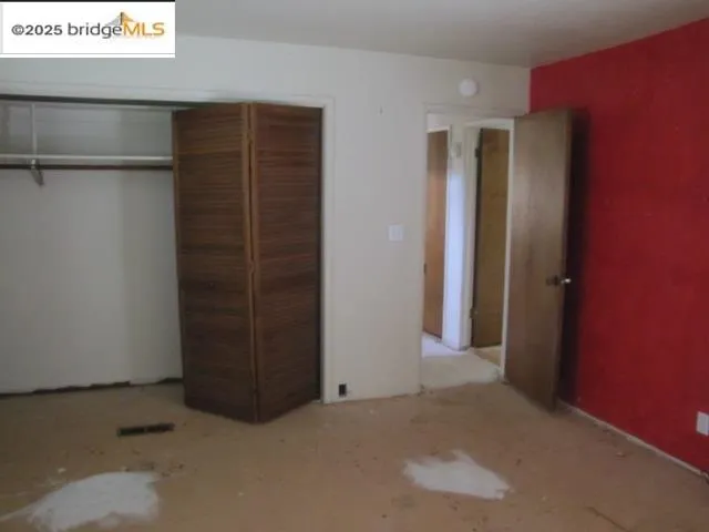 a view of a room with rack on the wall and a window