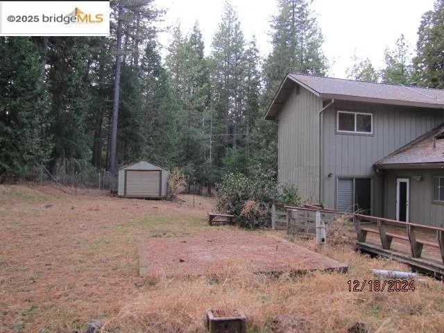 a view of house with a yard and seating space