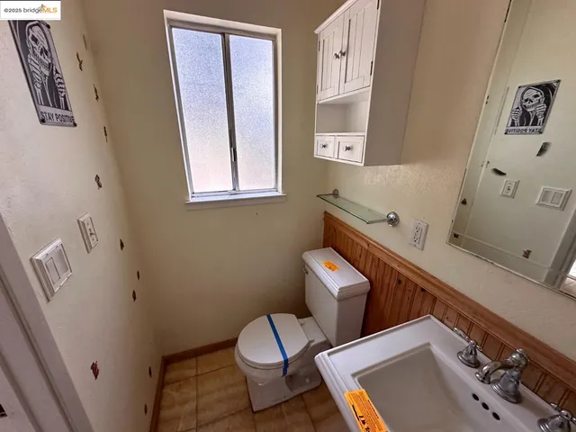 a bathroom with a sink a toilet and a mirror