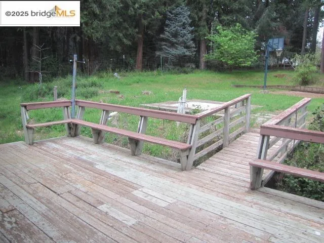 a view of a wooden deck and a yard