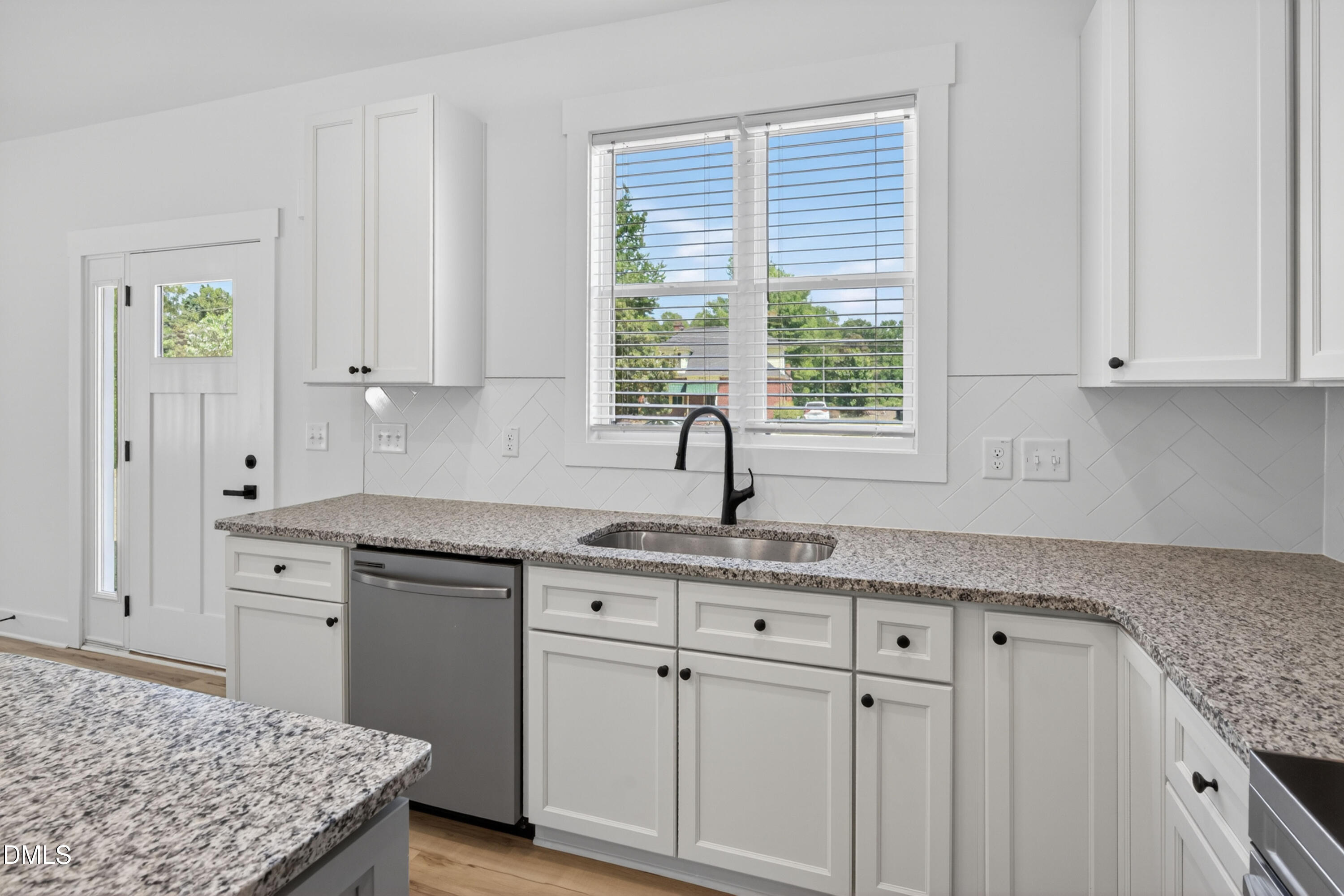 1182 Hurdle Mills Road Roxboro, NC 27573 - Photo 12 of 45 a kitchen with granite countertop white cabinets and sink