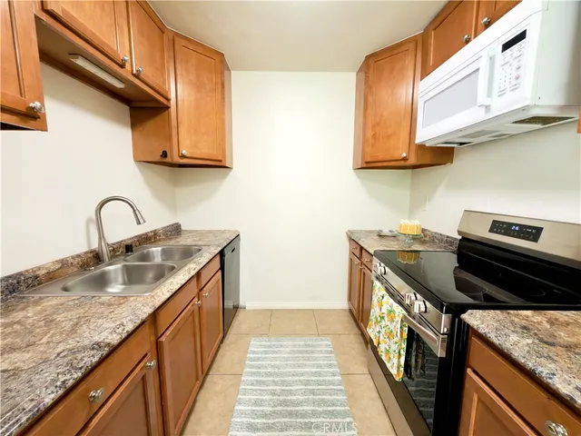 a kitchen with stainless steel appliances granite countertop a stove and a sink