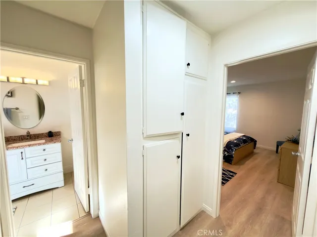 a walk in closet and bedroom view