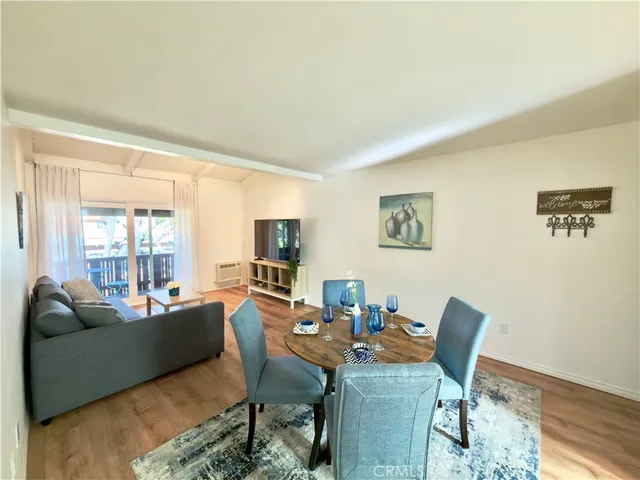 a living room with fireplace furniture and a large window