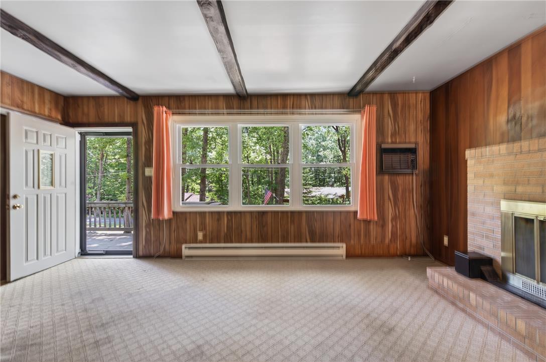 18 White Oak Road Nesquehoning, PA 18240 - Photo 13 of 52 Warm wood paneling and exposed beams create a cozy living space with views of the surrounding natural landscape.