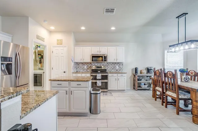 a kitchen with stainless steel appliances a stove sink and microwave