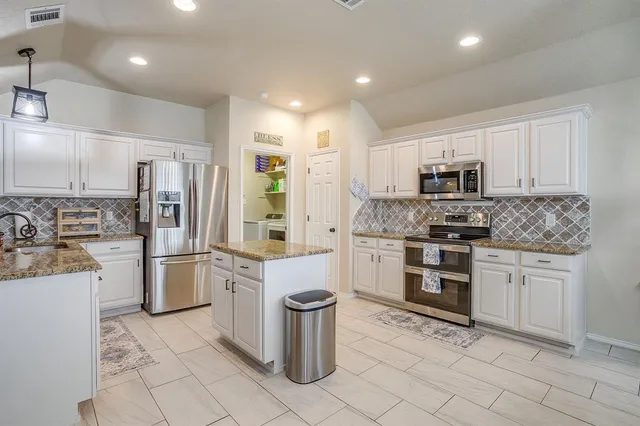 a kitchen with a sink stove and refrigerator