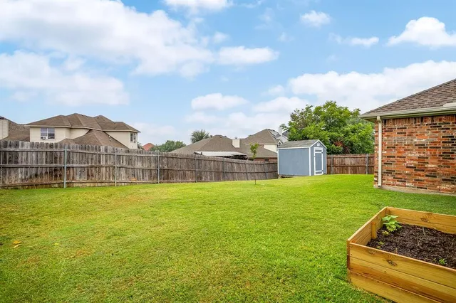 a view of a house with a yard and a garden