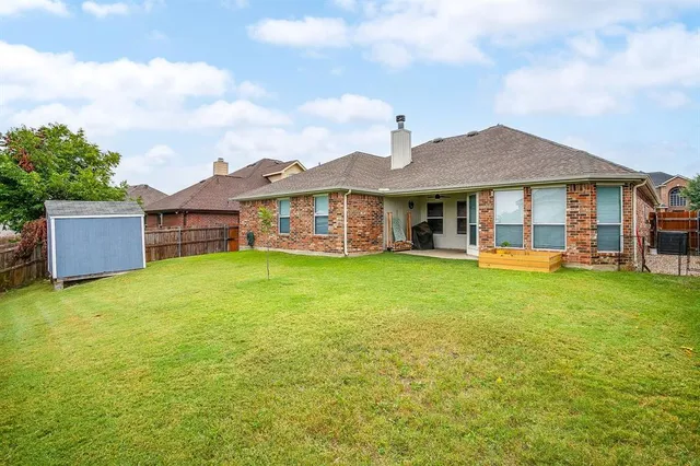a view of a house with a yard and sitting area