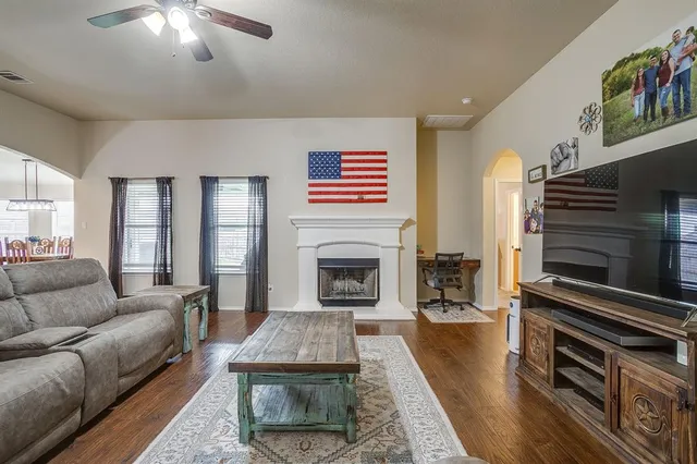 a living room with furniture and a fireplace