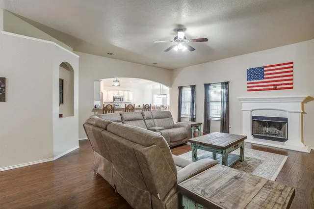 a living room with furniture and a fireplace