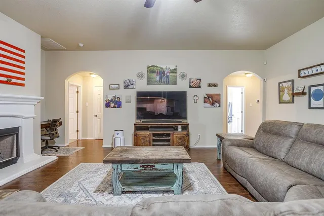a living room with furniture and a fireplace