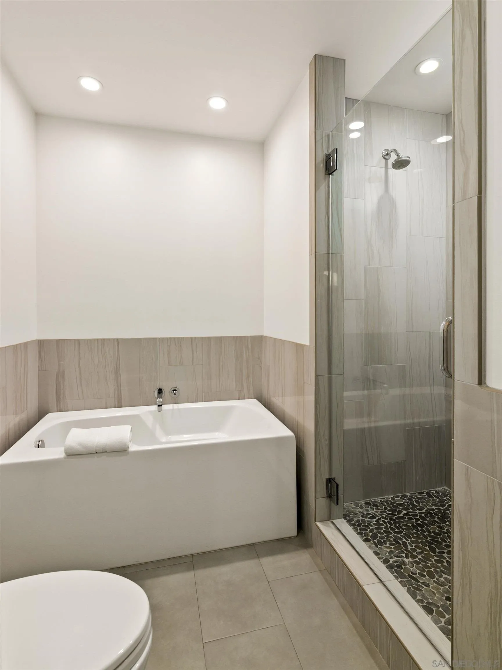 253 Gravilla Street La Jolla, CA 92037 - Photo 22 of 34 a bathroom with a bathtub and a shower