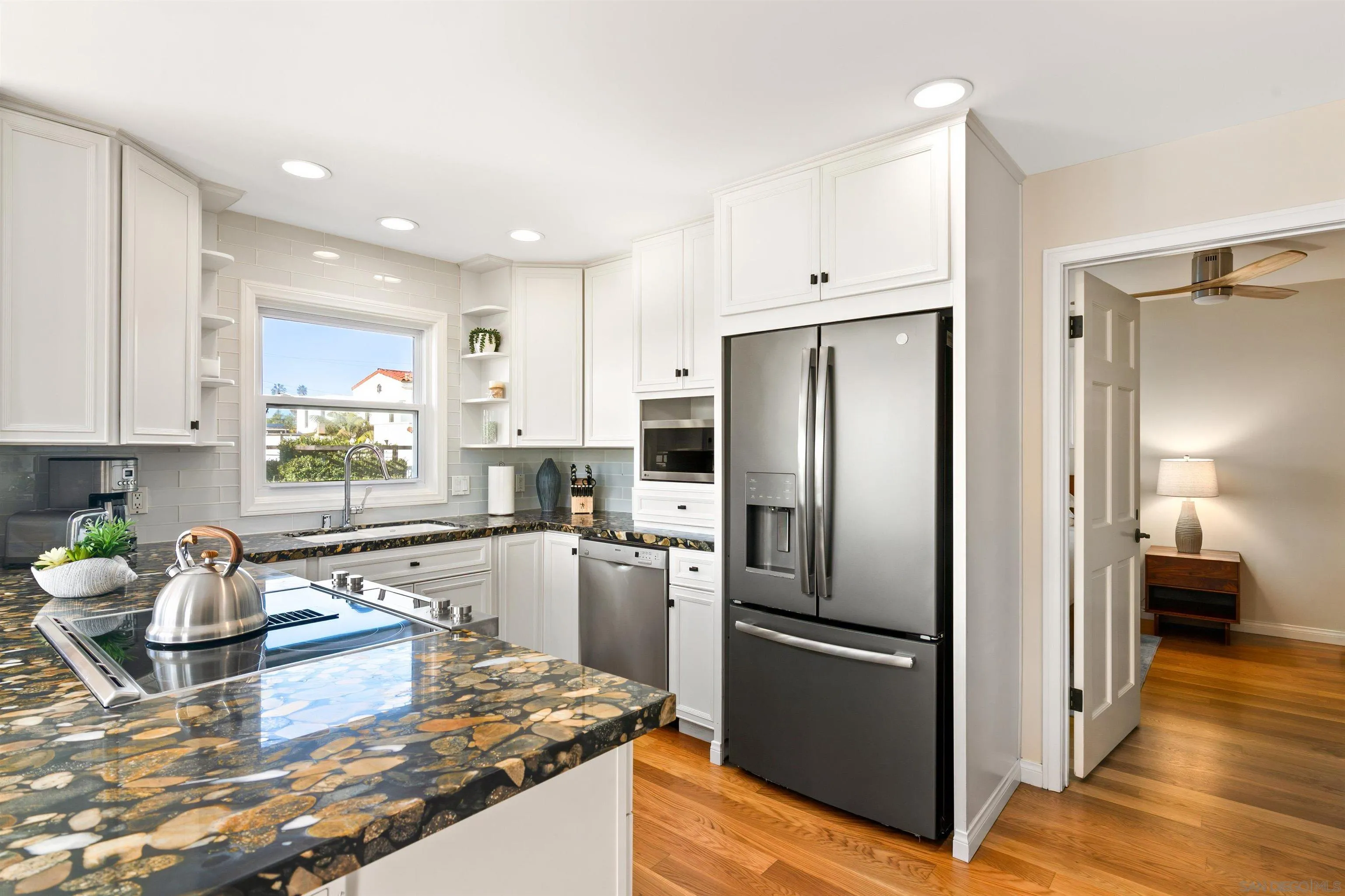 253 Gravilla Street La Jolla, CA 92037 - Photo 6 of 34 a kitchen with stainless steel appliances granite countertop a refrigerator and a stove