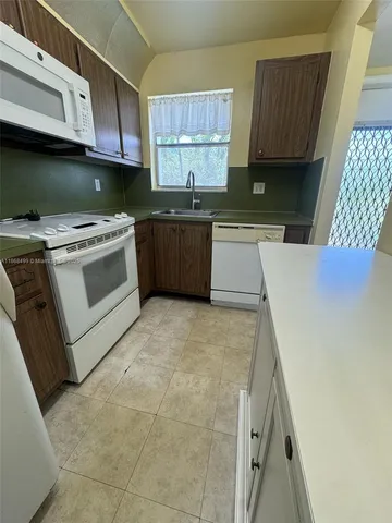 a kitchen with a stove a sink and a microwave