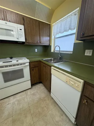 a kitchen with stainless steel appliances granite countertop a sink and a stove