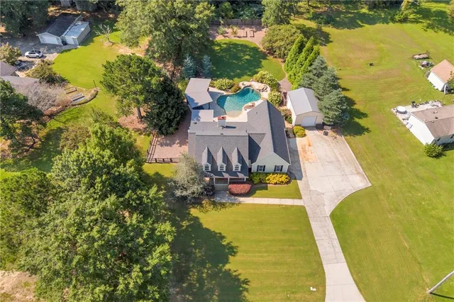 an aerial view of residential house with outdoor space and swimming pool