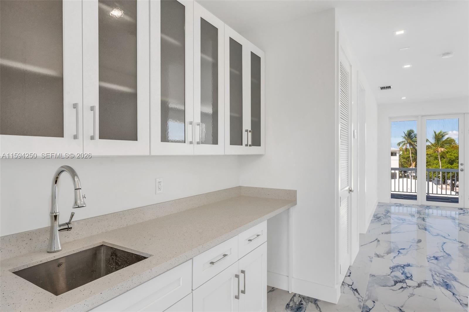84 Coral Way Key Largo, FL 33037 - Photo 27 of 55 a kitchen with a sink and cabinets