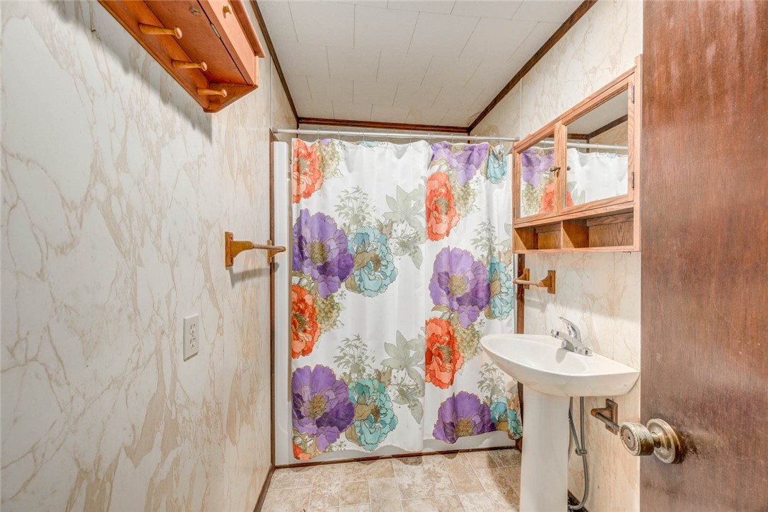 9047 County Road 461 Mathis, TX 78368 - Photo 18 of 38 a bathroom with a sink and a mirror