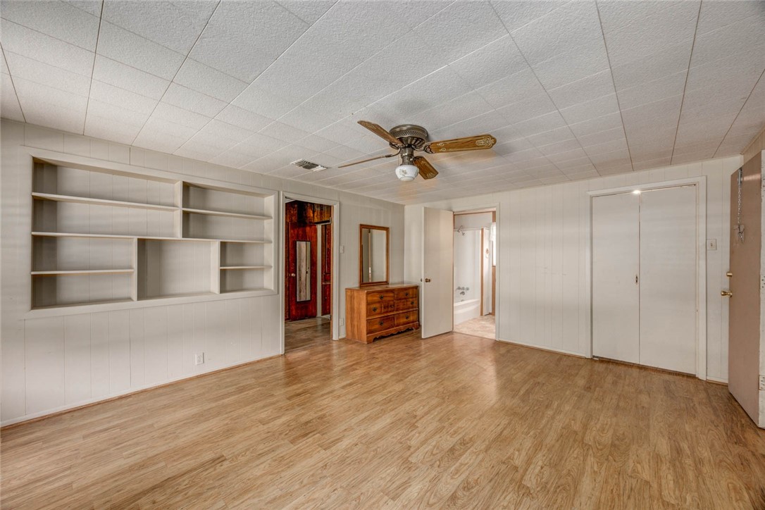 9047 County Road 461 Mathis, TX 78368 - Photo 22 of 38 a view of empty room with wooden floor and ceiling fan