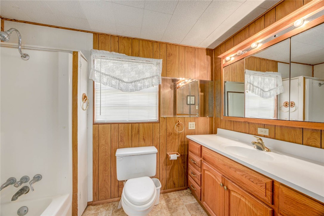 9047 County Road 461 Mathis, TX 78368 - Photo 24 of 38 a bathroom with a sink a toilet and shower