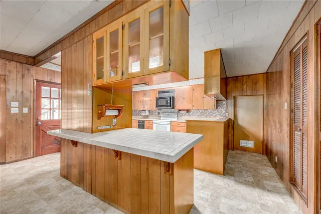 a kitchen with stainless steel appliances granite countertop a sink stove and cabinets