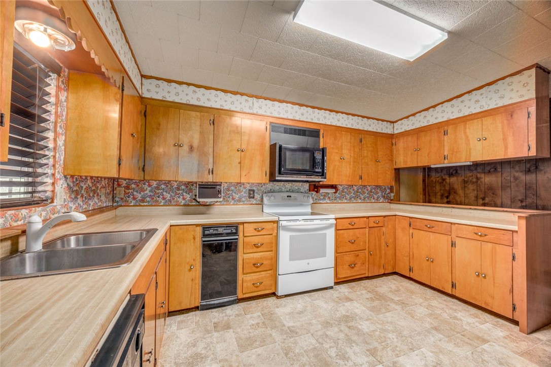 9047 County Road 461 Mathis, TX 78368 - Photo 29 of 38 a kitchen with stainless steel appliances granite countertop a sink stove and cabinets