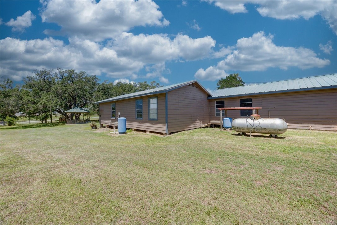9047 County Road 461 Mathis, TX 78368 - Photo 9 of 38 a backyard of a house with table and chairs