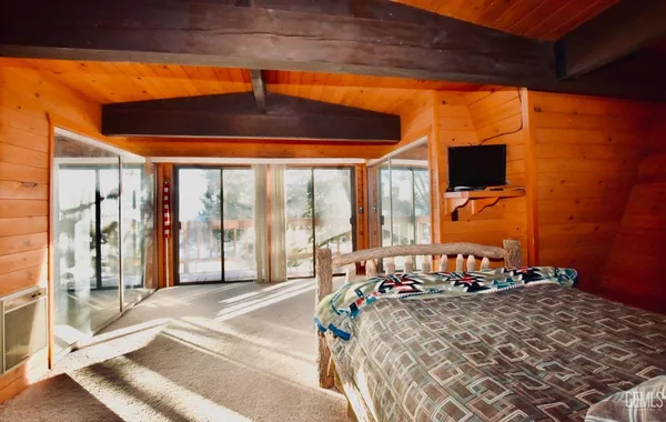 a bed room with a bed and a large window