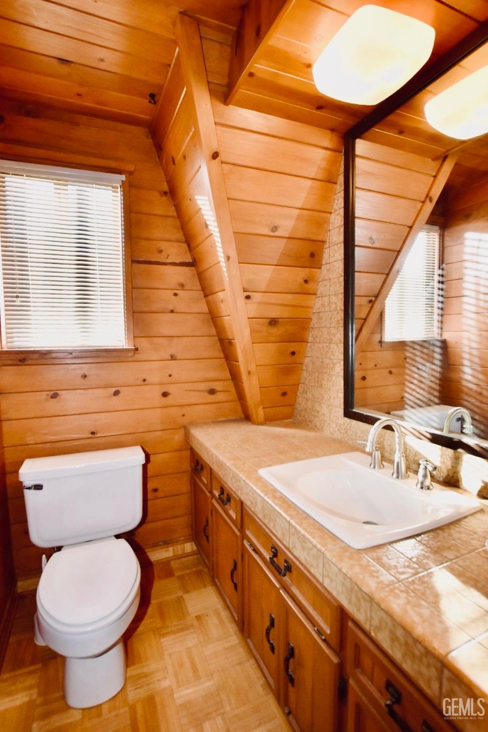 Undisclosed Address Tehachapi, CA 93561 - Photo 10 of 17 a bathroom with a granite countertop toilet sink and mirror