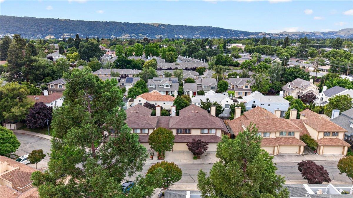 244 Rachael Place Pleasanton, CA 94566 - Photo 23 of 24 an aerial view of a city with lots of residential buildings and mountain view in back