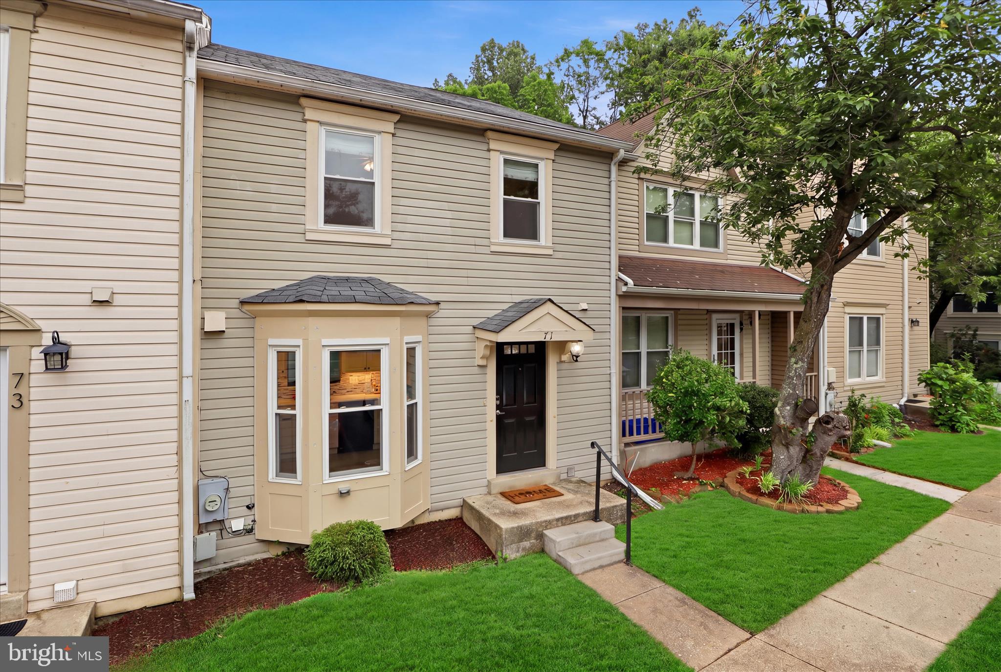 71 Kinsman View Circle Silver Spring, MD 20901 - Photo 38 of 42 a front view of a house with garden