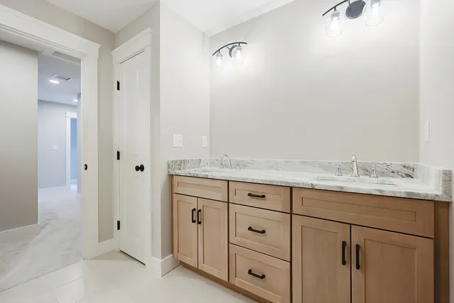 a bathroom with a granite countertop sink and a mirror