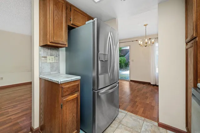a kitchen with stainless steel appliances granite countertop a refrigerator and a stove